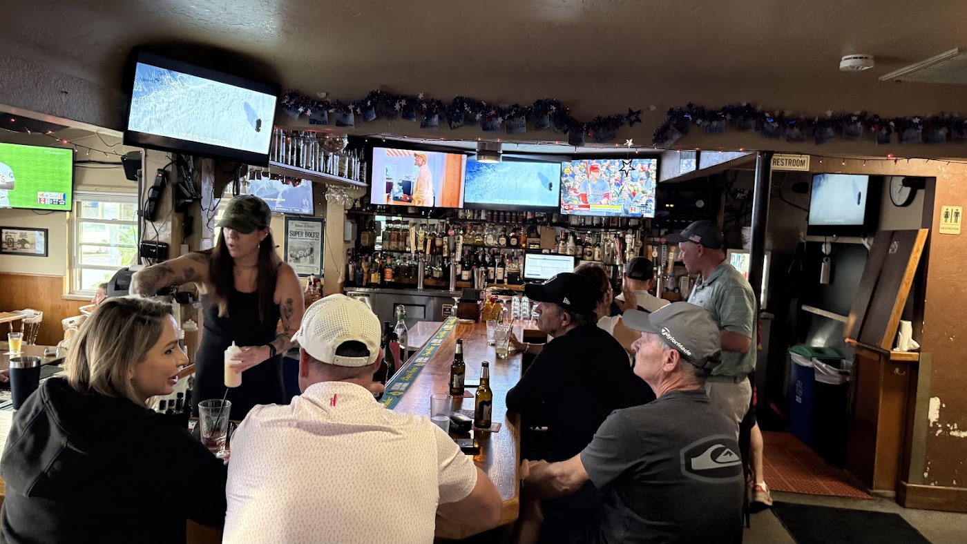 Bar room with TVs and guests at Grand Avenue Bar & Grill